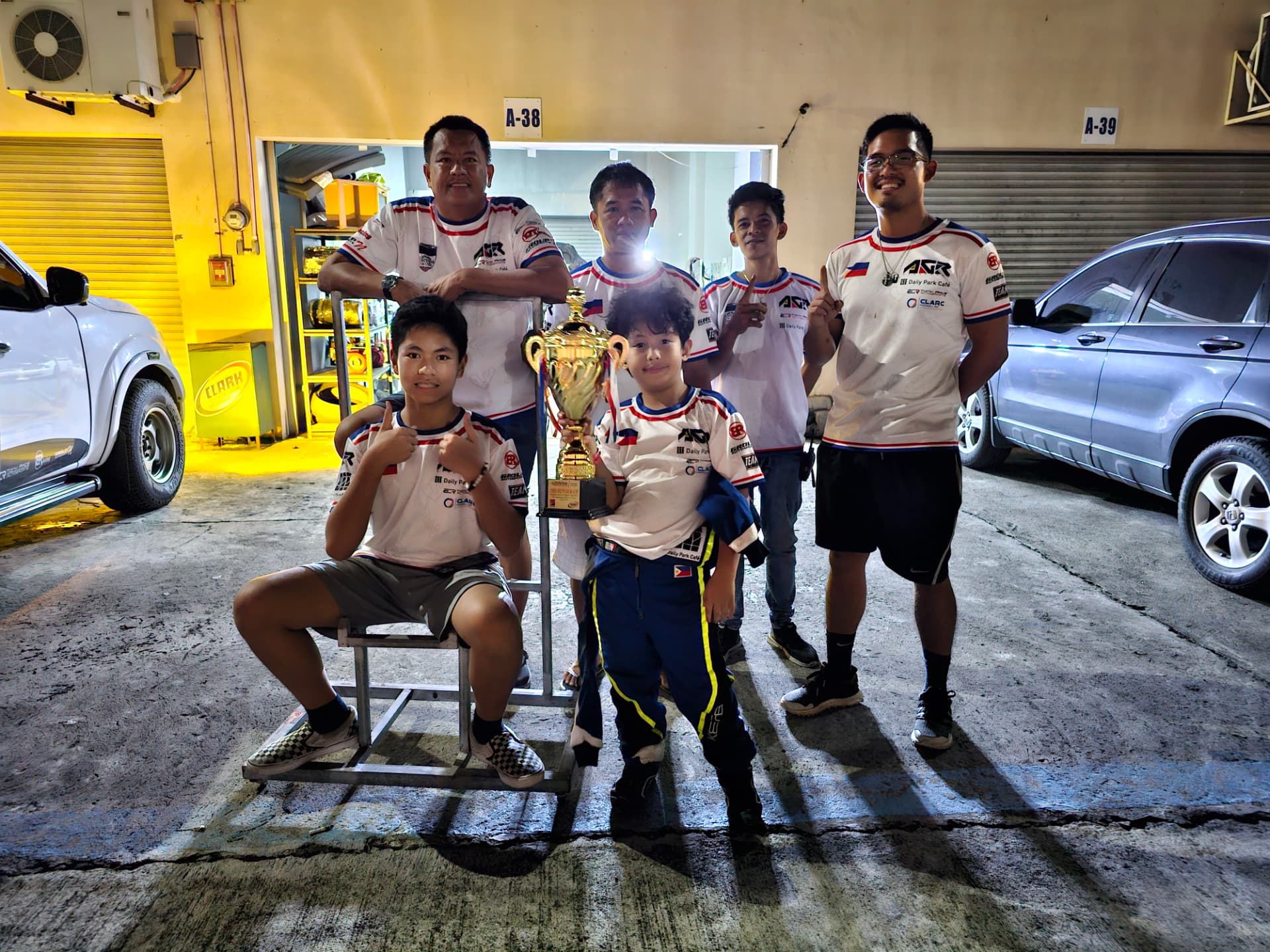 Antonio Racelis with his team and a trophy