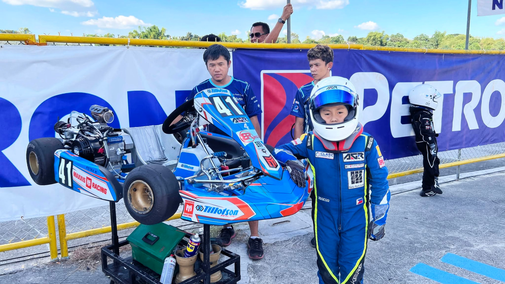 Antonio Racelis in racing gear beside his kart at Clark
