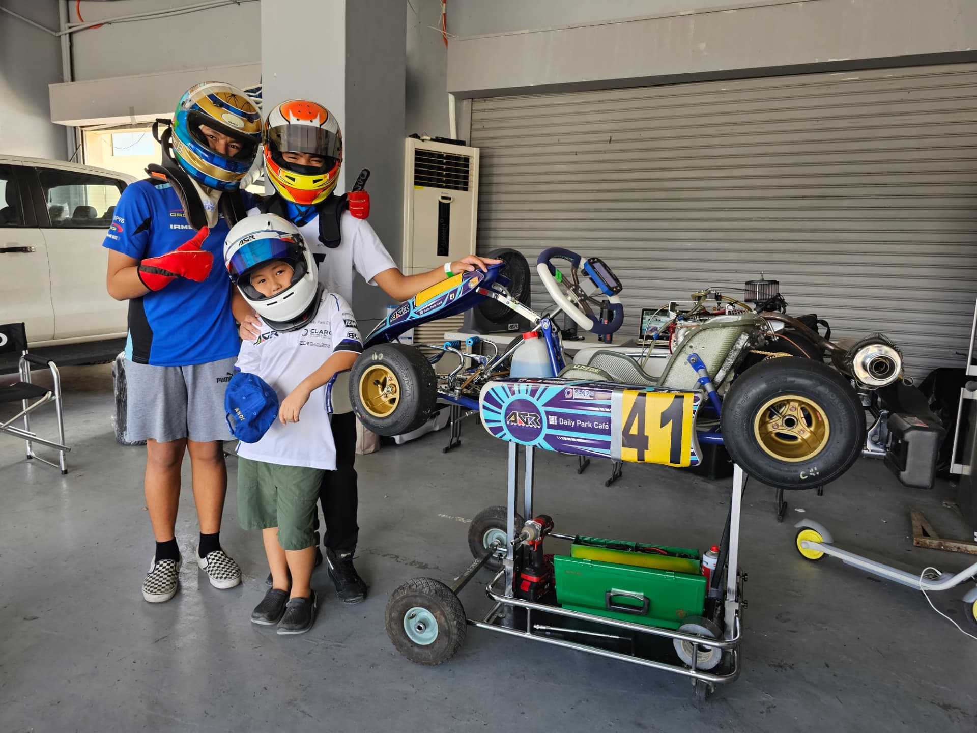 Antonio Racelis with other drivers beside kart number 41