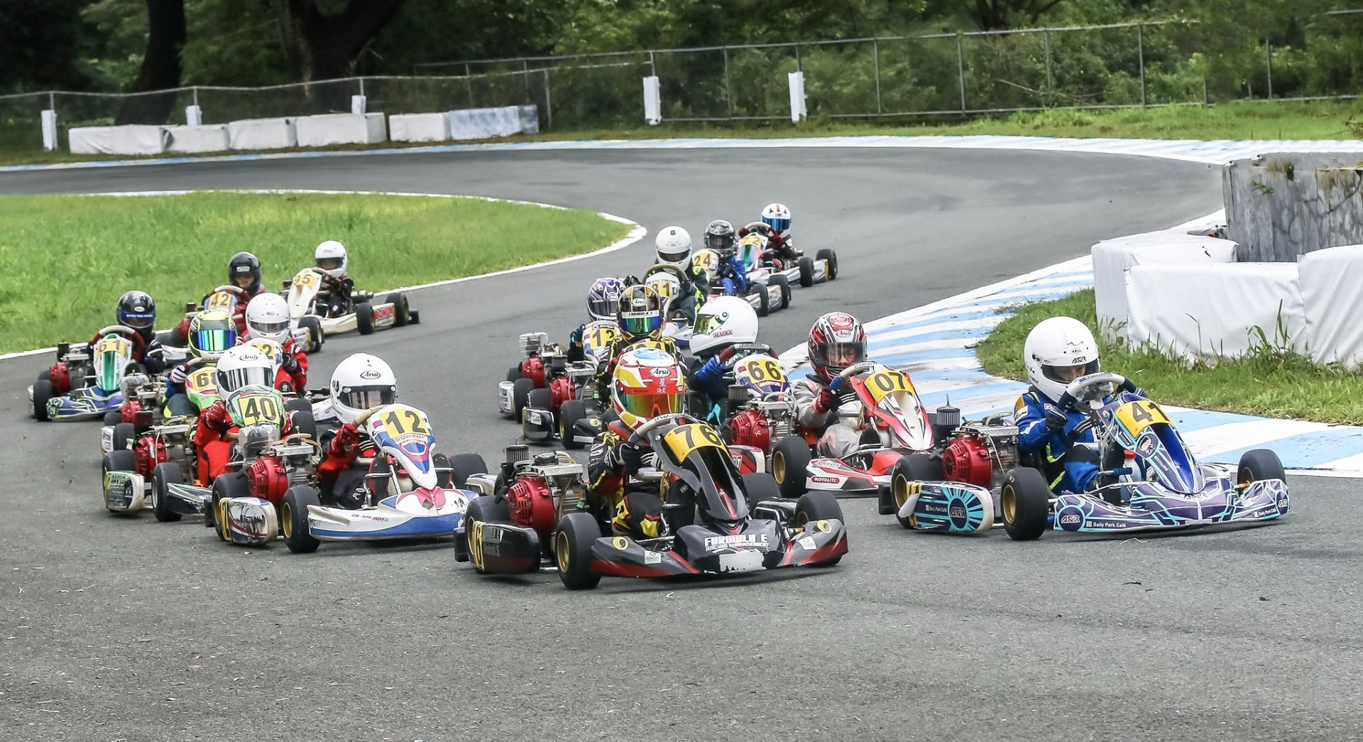 Karting field racing through a corner in Macau