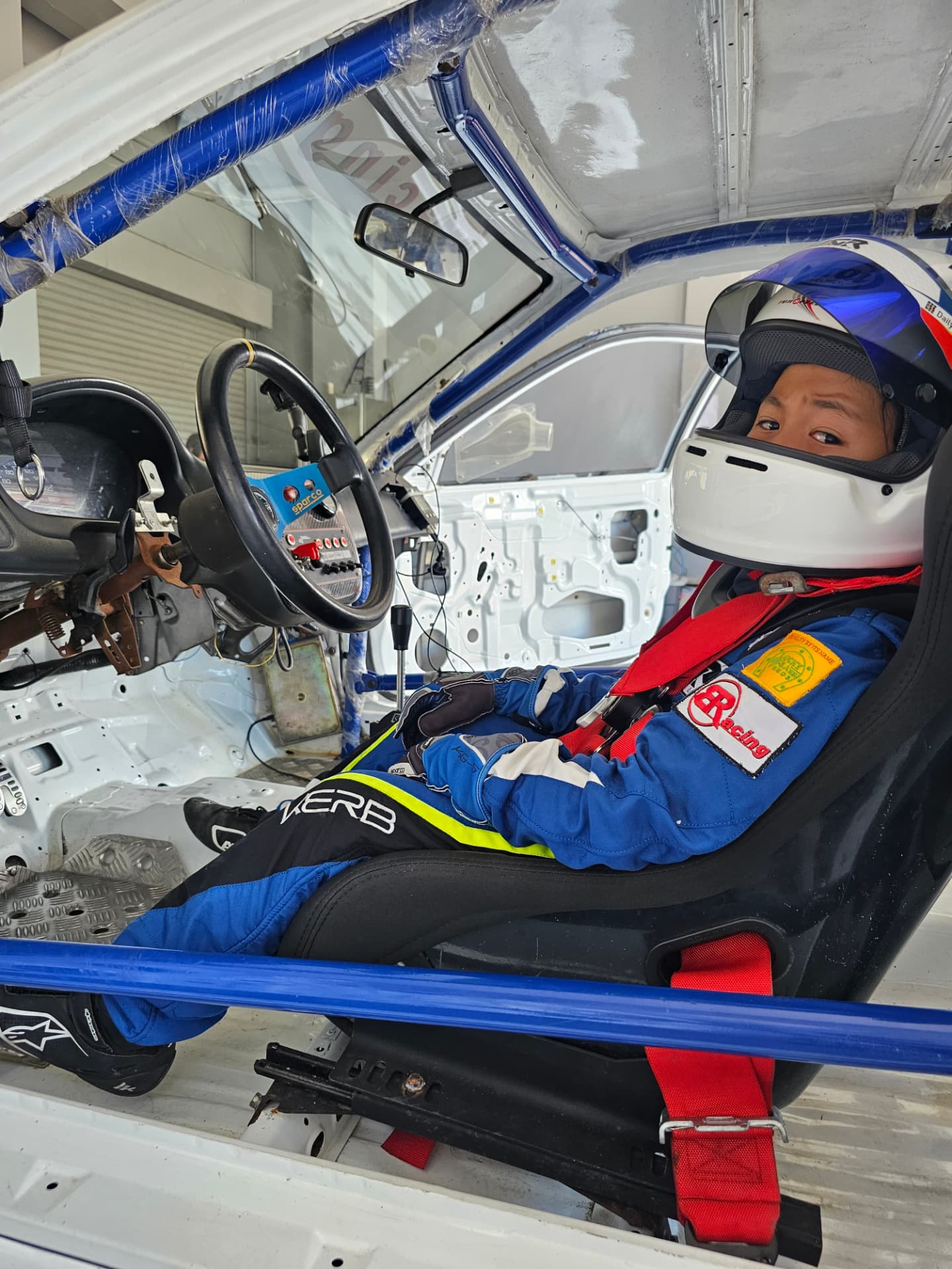 Antonio Racelis seated in a race car