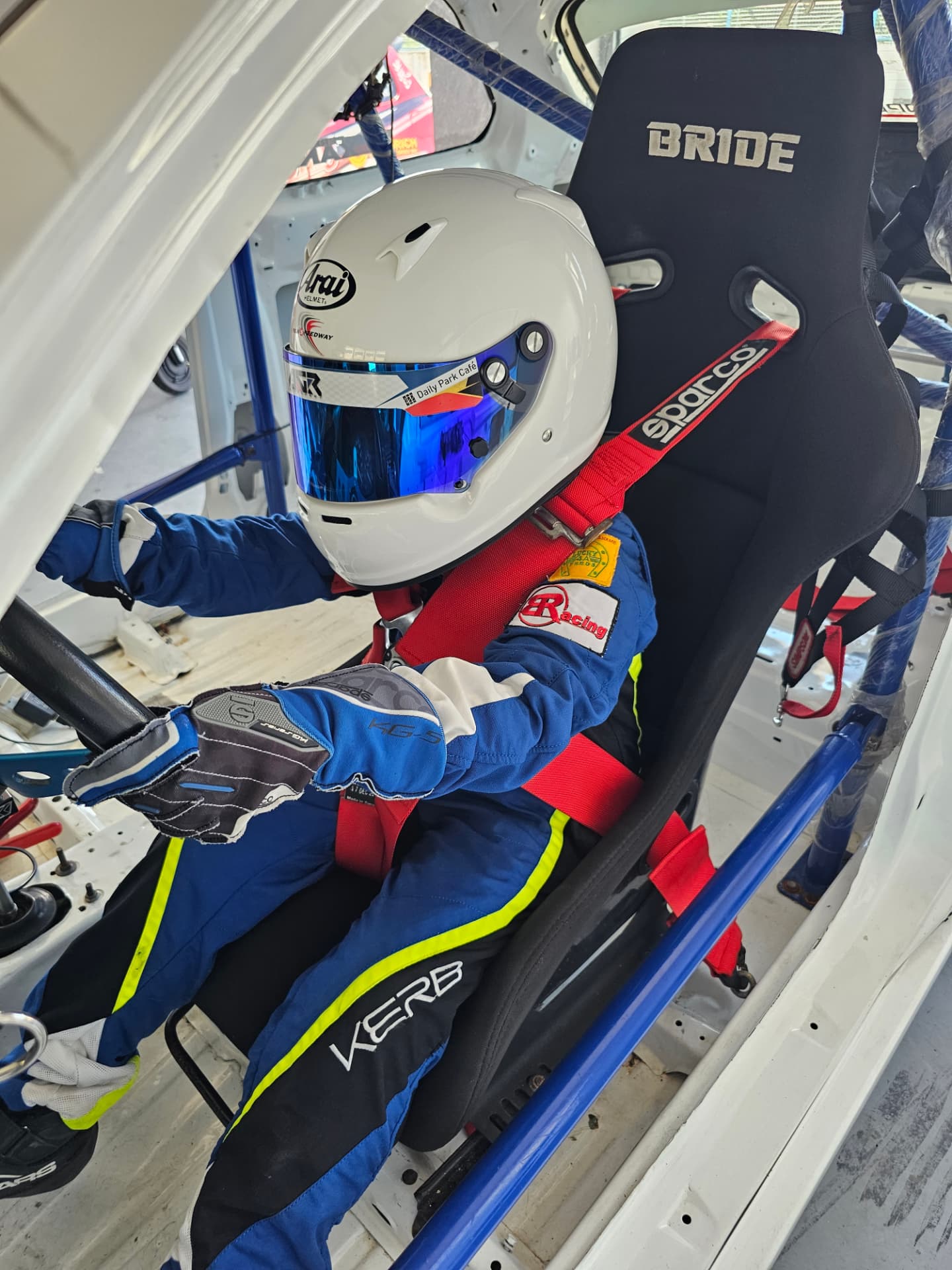 Antonio Racelis wearing his helmet in a race car
