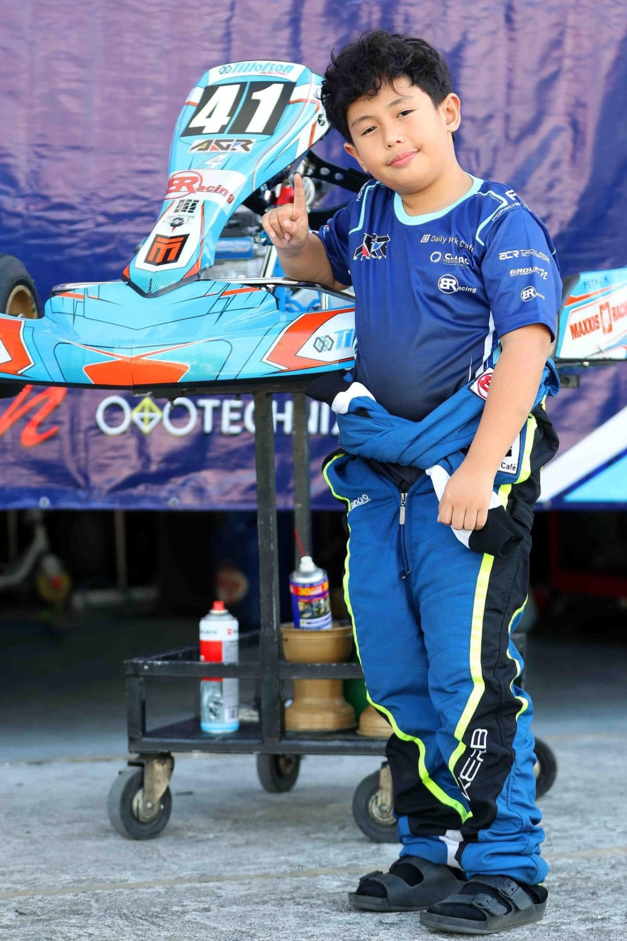 Antonio Racelis standing beside kart number 41