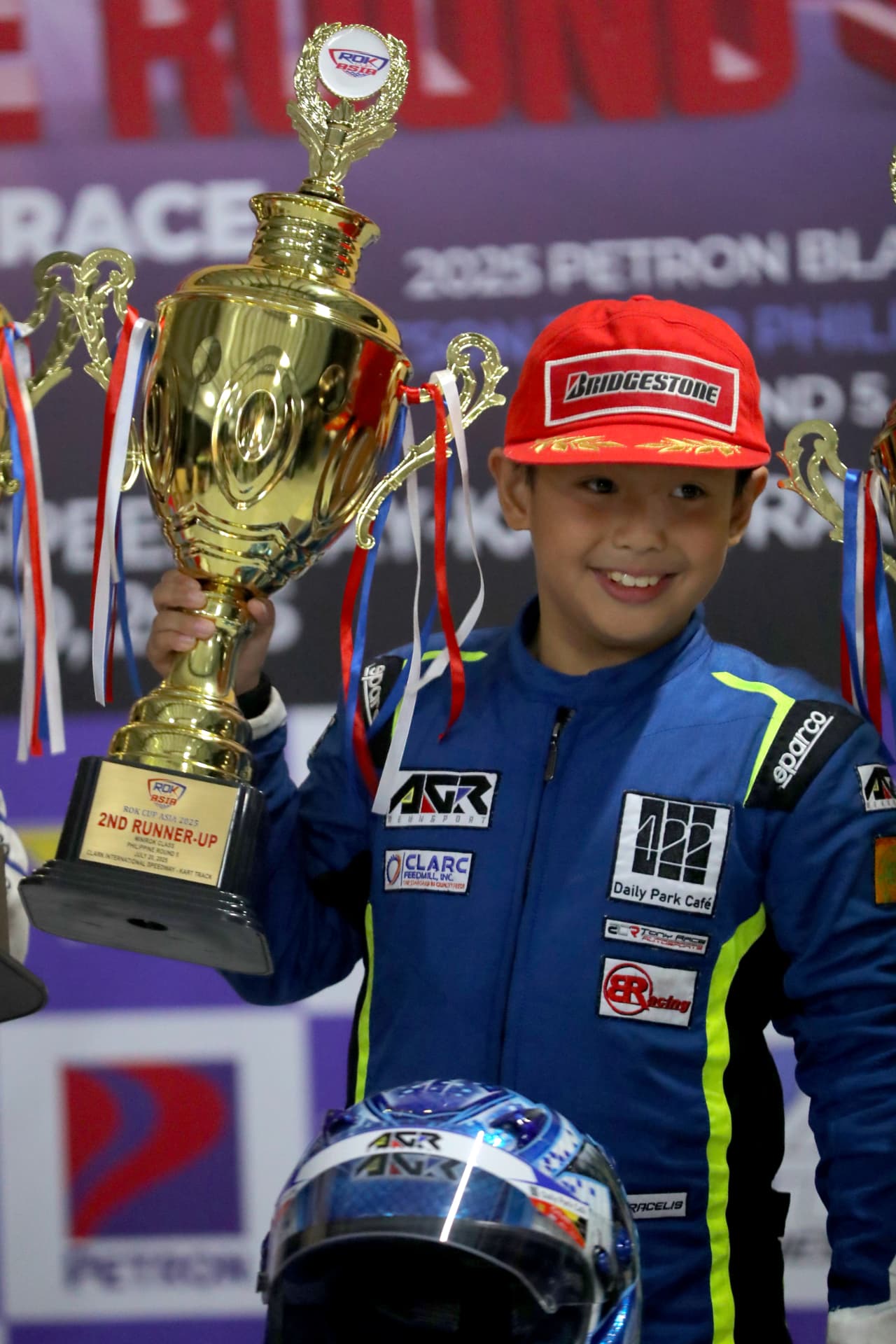 Antonio Racelis holding his podium trophy