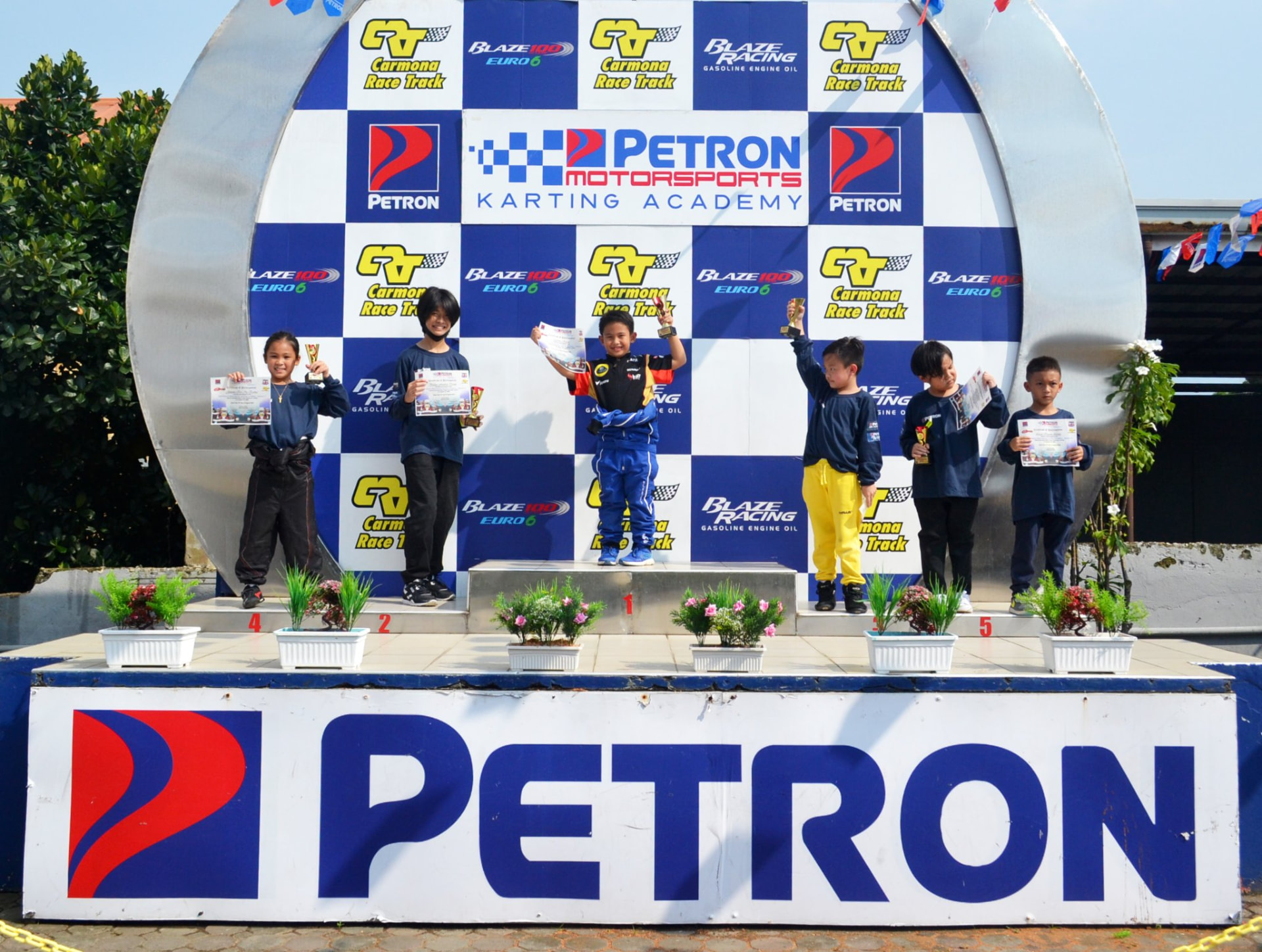 Karting academy participants on the podium