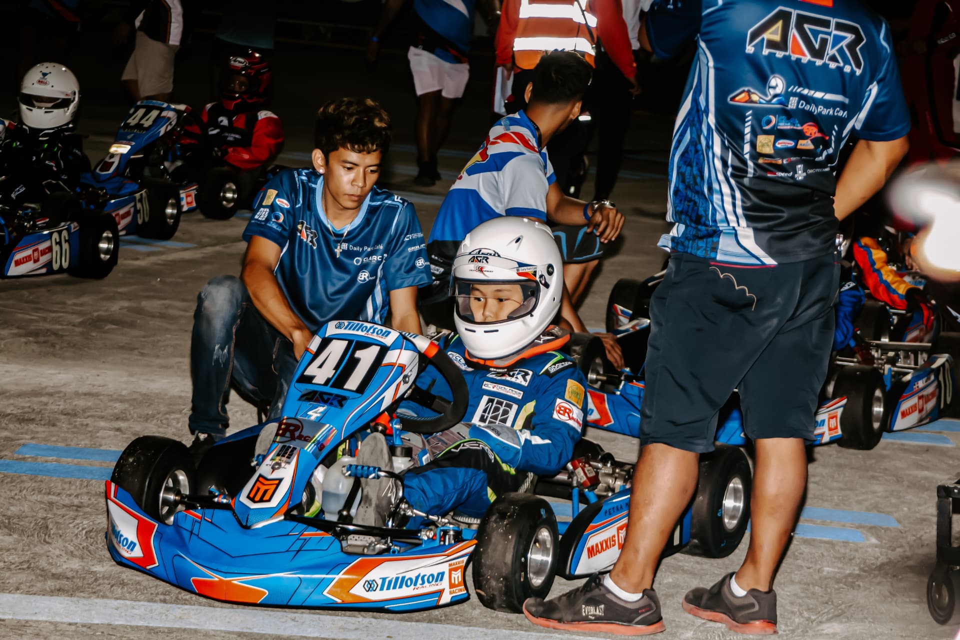 Antonio Racelis seated in kart number 41 with his team